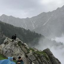 a group of people standing on top of a mountain