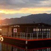 a ferry boat in the water with the sunset
