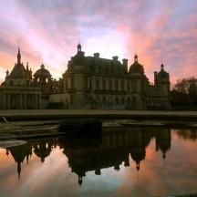 a large building with a reflection in the water