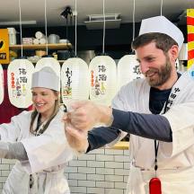 a man and a woman holding hands in a kitchen