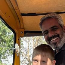 a man and a boy sitting in a vehicle