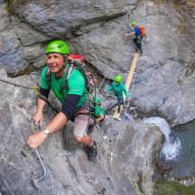 a group of people climbing on a rock wall