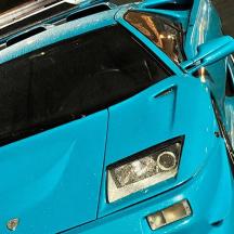 a blue car is parked on the street