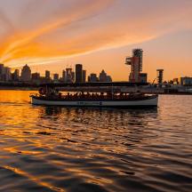 a boat in the water with a city in the background