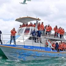 a group of people on a boat in the water
