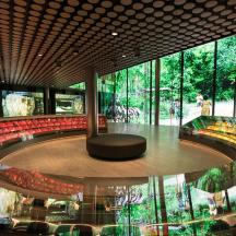 a large auditorium with a round stage and red chairs
