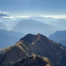 a view of a mountain with clouds in the background
