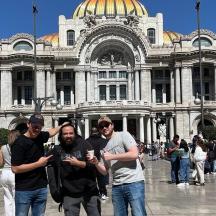 a group of men standing in front of a building