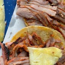 a sandwich with bacon and cheese on a blue plate