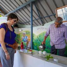 a man and a woman standing at a food stand