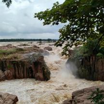 a waterfall in the middle of a river