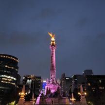 a statue in the middle of a city at night