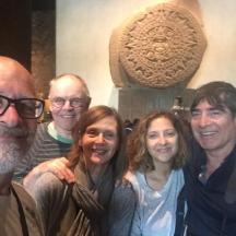 a group of people posing in front of a statue