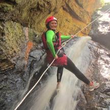 una dona està dreta sobre una corda en una cascada