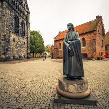 a statue of a man standing on a street