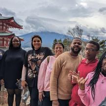 a group of people standing in front of a pagoda