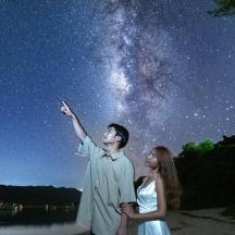 a man and a woman looking up at the night sky