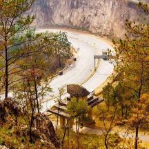 a winding road in the mountains with a winding road