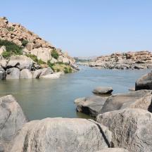 a river with large rocks in the middle