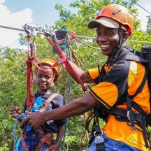 a man and a child on a zip line