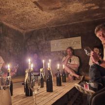 a group of people sitting around a table with candles