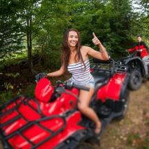 a woman is sitting on a quad bike