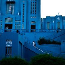 a person walking down the stairs of a blue building
