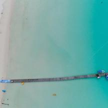 an overhead view of a beach with a kite