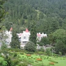 a large white house in the middle of a park