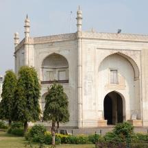a large white building with trees in front of it