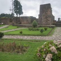 a view of a garden with a castle in the background