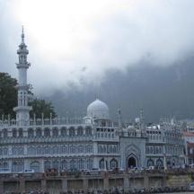 a large building with a mosque in a city