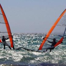 two people are windsurfing in the ocean