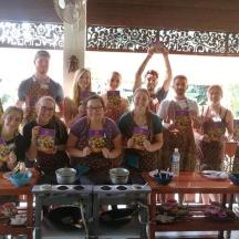 a group of people in aprons posing for a picture