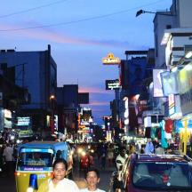 a busy city street with cars and people on the street