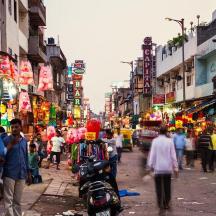 a busy city street with people walking and shops