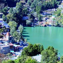 an aerial view of a town with a lake