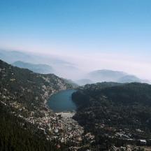 a view of a city and a lake in the mountains