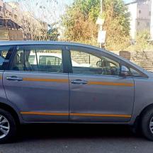 a silver car with orange stripes parked on a street