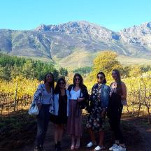 a group of women standing in front of a mountain