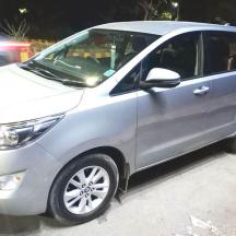 a silver minivan parked in a parking lot