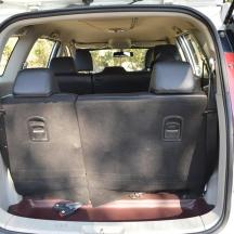an open trunk of a car with the back door open