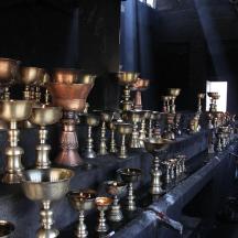 a bunch of copper vases sitting on a table