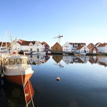a boat is docked in the water next to houses