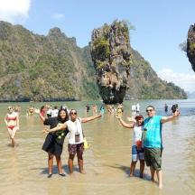 a group of people standing in the water at a beach