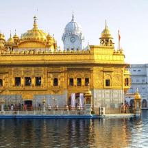a woman standing in front of a golden temple