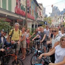 a group of people standing on a street with bikes