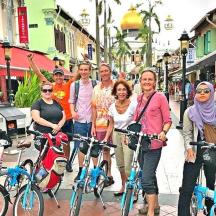 a group of people standing on a street with bikes