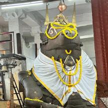 a statue of a person wearing a crown and chains