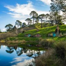 a house on a hill next to a body of water